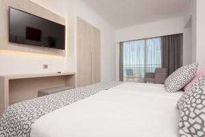 Postel nebo postele na pokoji v ubytování Hotel Timor