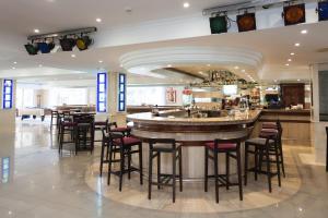 a bar in a restaurant with bar stools at Hotel Timor in Playa de Palma