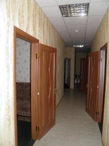a hallway with wooden doors in a room at Atrium Hotel in Melitopol