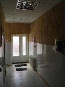a bathroom with a door and a tile floor at Atrium Hotel in Melitopol