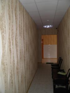 a meeting room with a wall with wood paneling at Atrium Hotel in Melitopol