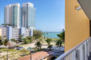 a balcony with a view of the beach and buildings at 23 Palms Suites - Midtown Wynwood in Miami