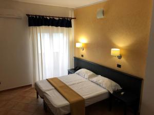 Postel nebo postele na pokoji v ubytování Residence Hotel Antica Perla