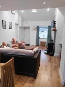 a bedroom with a bed and a living room at Elm Cottage in Cong