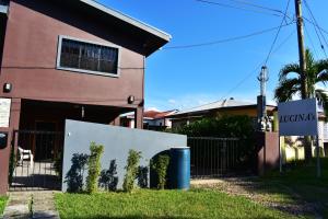 a building with a fence and plants on it at Lucina's in San Ignacio