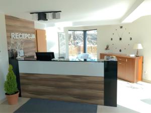 an office lobby with a reception desk with wood at Hotel Europa in Elblag