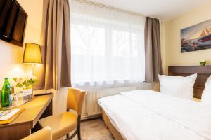 Ένα ή περισσότερα κρεβάτια σε δωμάτιο στο Hotel Mukran