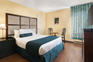Ένα ή περισσότερα κρεβάτια σε δωμάτιο στο Hotel Days Inn Blainville & Centre de Conférence +23 φωτογραφίες