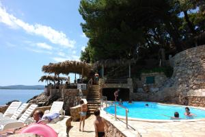 a group of people in a pool at a resort at Wine Resort Adriatic Mikulic in Orebić