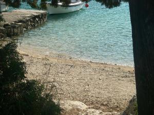a beach with a boat in the water at Villa Conte in Korčula +81 photos