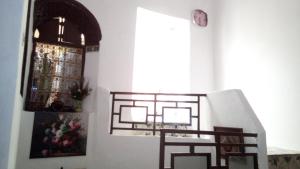 a staircase in a room with a window and a picture at Dar Al Taaj in Rabat