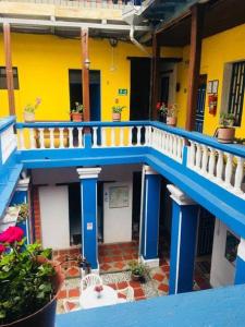 a blue and yellow building with a blue and white staircase at Blue Door Housing Historic Quito in Quito