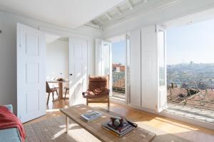 a living room with a table and a large window at B28 Apartments Porto in Porto