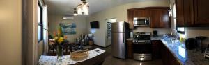 a kitchen with a refrigerator and a counter top at Captain Jak's Rentals in Placencia Village