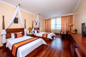 Ein Bett oder Betten in einem Zimmer der Unterkunft Pacific Hotel & Spa