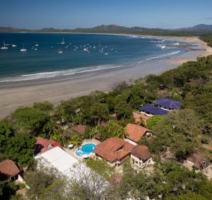 an aerial view of the beach and houses at Casa Woodbine Private House on Tamarindo Beach in Tamarindo