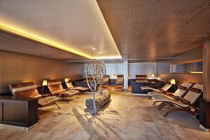 a lobby with couches and chairs in a room at Sporthotel Silvretta Montafon in Gaschurn