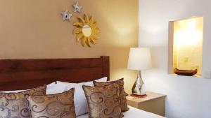 a bedroom with a bed with a sun clock on the wall at Casa Embrujo Morelia - Boutique in Morelia