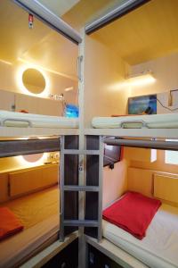 a room with two bunk beds in it at INAP at Capsule Hostel in Bandung