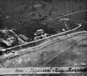 a black and white photo of a street with a bus at Le Petit Chateau in Bar