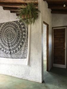 a wall with a mosaic on the side of a building at La casa de la paz in Potrerillos