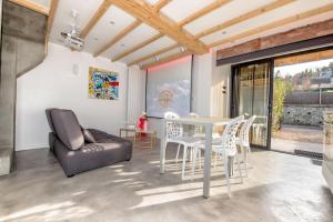 a living room with a white table and chairs at The Tiny House in Honfleur