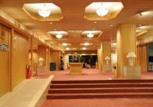 a lobby with stairs and lights in a building at Hotel Nakamuraya in Shiojiri