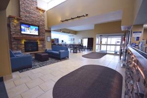 a lobby with a living room with a fireplace at Best Western Resort Hotel & Conference Center Portage in Portage