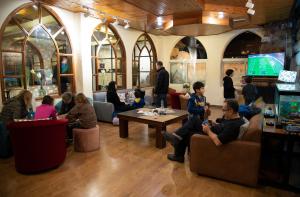 a group of people sitting in a room at Chateau D'eau Hotel in Fārayyā