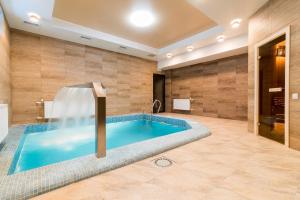 a large bathroom with a large tub in the middle at LaCasa Hotel in Karagandy