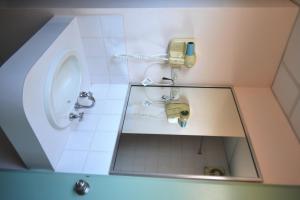a bathroom with a sink and a mirror at The Lodge Motel in South Hedland