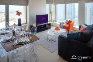 a living room with a table and a couch at Dream Inn Apartments - 29 Boulevard Private Terrace in Dubai