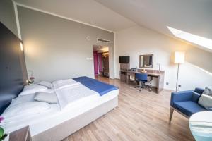 Postel nebo postele na pokoji v ubytování Hotel Orangerie