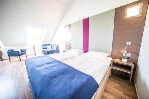 Postel nebo postele na pokoji v ubytování Hotel Orangerie
