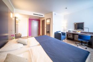 Postel nebo postele na pokoji v ubytování Hotel Orangerie