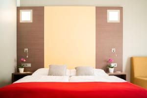 Postel nebo postele na pokoji v ubytování Hotel Orangerie