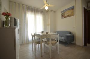 a living room with a white table and chairs at Appartamenti Alisei e Cristina in Bibione