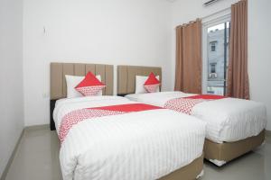 Voodi või voodid majutusasutuse OYO 443 Hotel Barlian toas