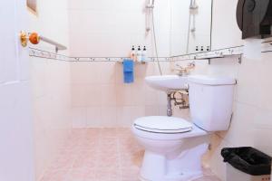 a bathroom with a toilet and a sink at White Cabin in Pyeongchang