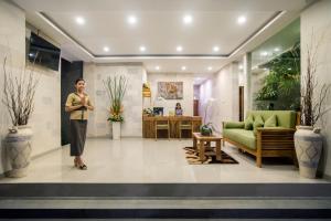 a man is standing in a lobby at Sandi Agung Villa Bidadari in Seminyak