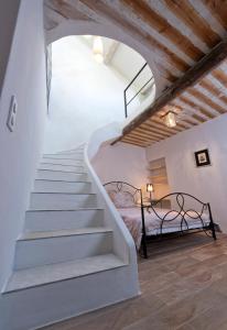 Una escalera que conduce a un dormitorio con cama en Mas du Sommelier, en Le Beaucet