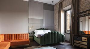 a bedroom with a bed and a couch at Chapter Roma in Rome