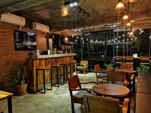 un restaurante con mesas y sillas y un bar en Ton Fang Hotel, en Fang