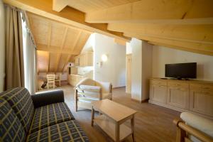 a living room with a couch and a table at La Casa al Noce in Mezzana