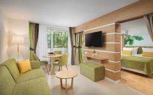 a hotel room with a bed and a television at Hotel Forest Beach in Primorsko
