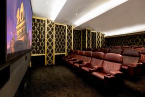 a cinema room with leather chairs and a stage at Pepperclub Hotel in Cape Town