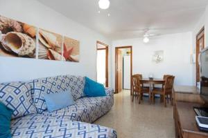 a living room with a couch and a table at Apartment Claveles 2 in Telde