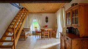 a room with a staircase and a dining room with a table at Fewo Schächtelschleif in Waldmünchen