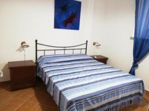 A bed or beds in a room at LudoMar Country Residence - Rooms & Apartments