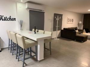 a living room with a white table and chairs at Spat Apartments in Bat Yam